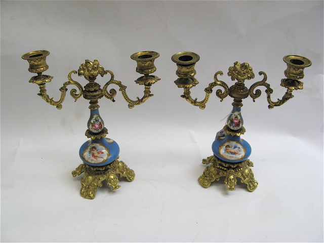 Appraisal: PAIR OF ROYAL VIENNA PORCELAIN GILT METAL CANDELABRA having cartouches