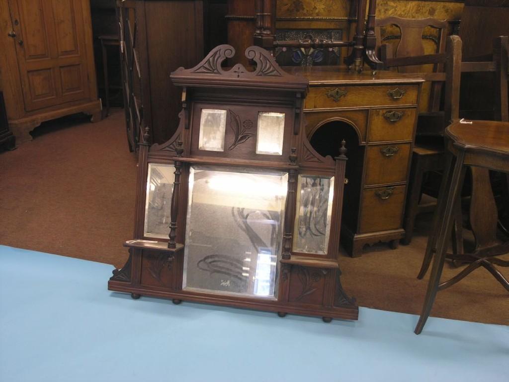 Appraisal: A late Victorian walnut overmantel architectural-shape with swan-neck cresting arrangement