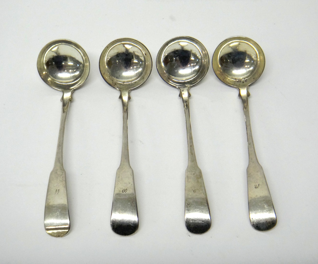 Appraisal: Four George IV Scottish silver fiddle pattern toddy ladles numbered