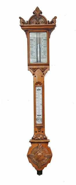 Appraisal: A VICTORIAN GOLDEN OAK STICK BAROMETER the double angled white