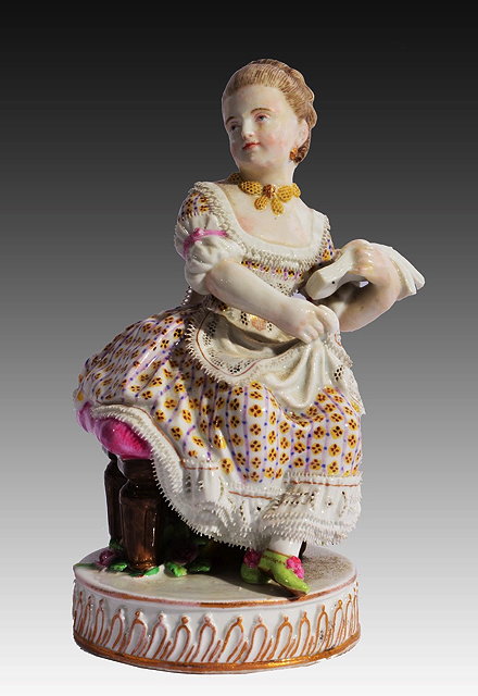 Appraisal: A MEISSEN FIGURE of a girl circa wearing a lace