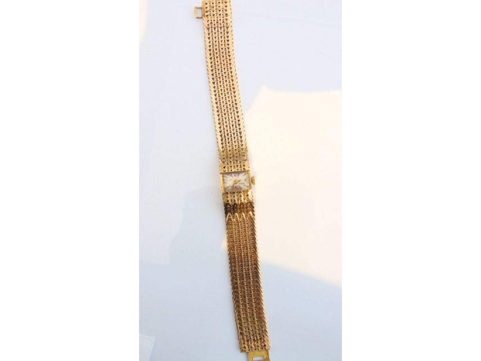 Appraisal: A lady's French gold wristwatch Exacta the rectangular dial with