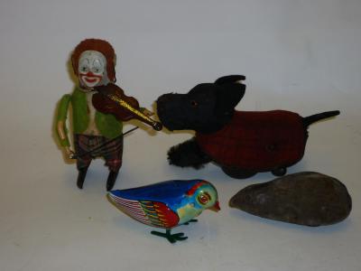 Appraisal: A Schuco tinplate novelty toy clown fiddler with clockwork action