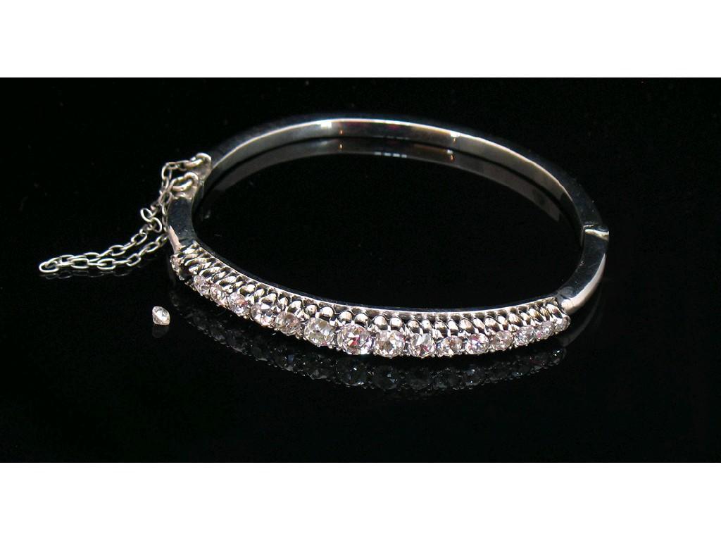 Appraisal: A DIAMOND-SET BANGLE the white metal bangle claw-set to the