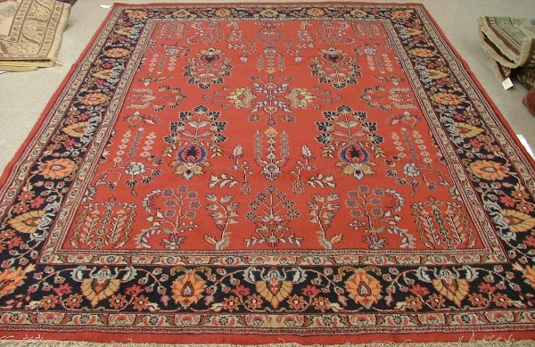 Appraisal: ORIENTAL INDO-SAROUK CARPET floral sprig design on red ground '