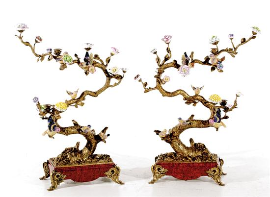 Appraisal: Pair Continental porcelain and bronze bird trees scrolling trunk and