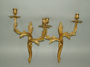 Appraisal: A pair of rococo style ormolu foliate scroll twin branch