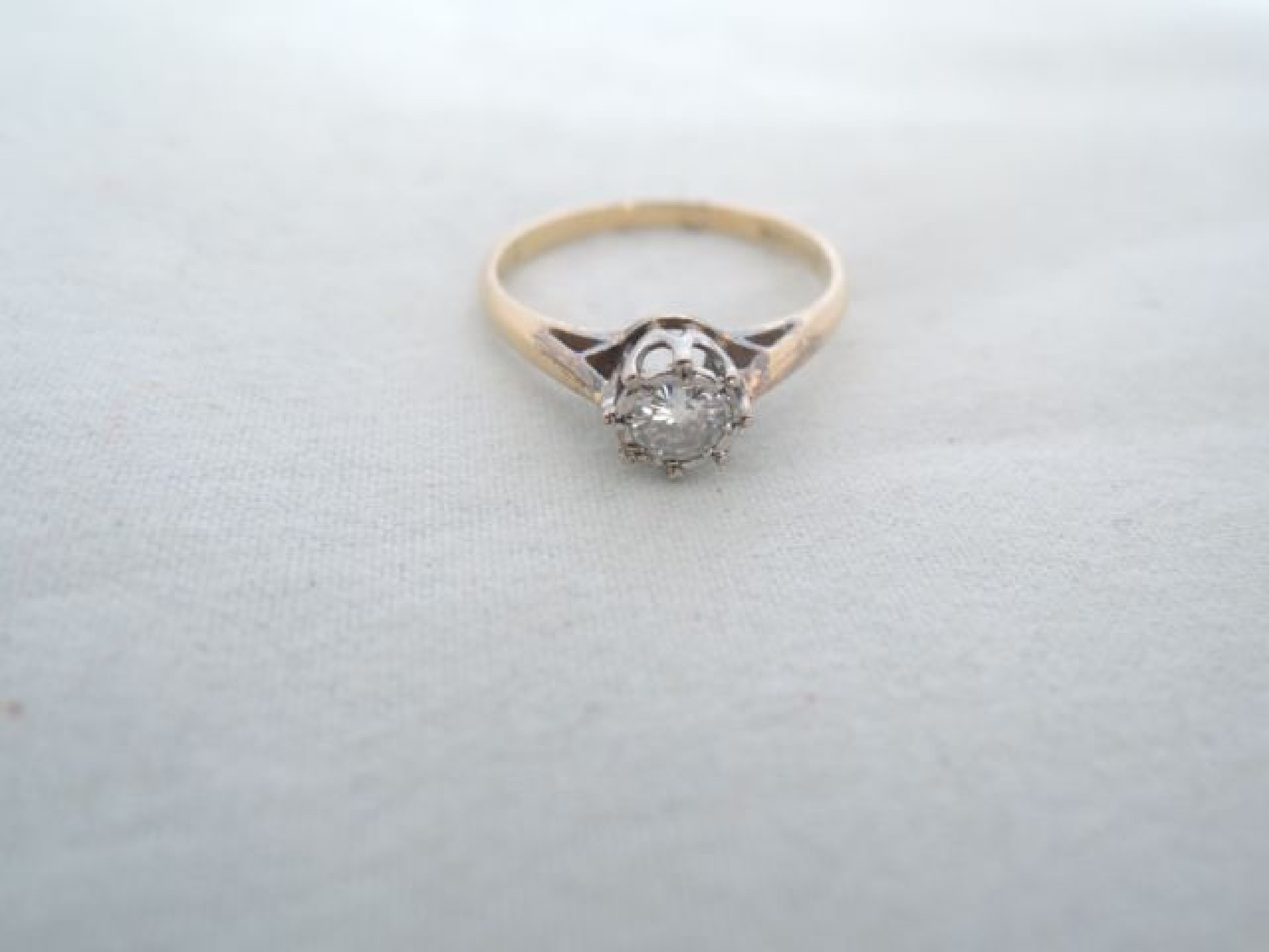 Appraisal: A solitaire diamond ring centred with a round brilliant-cut diamond