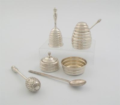 Appraisal: A tea infuser with a baluster stem and a bayonet