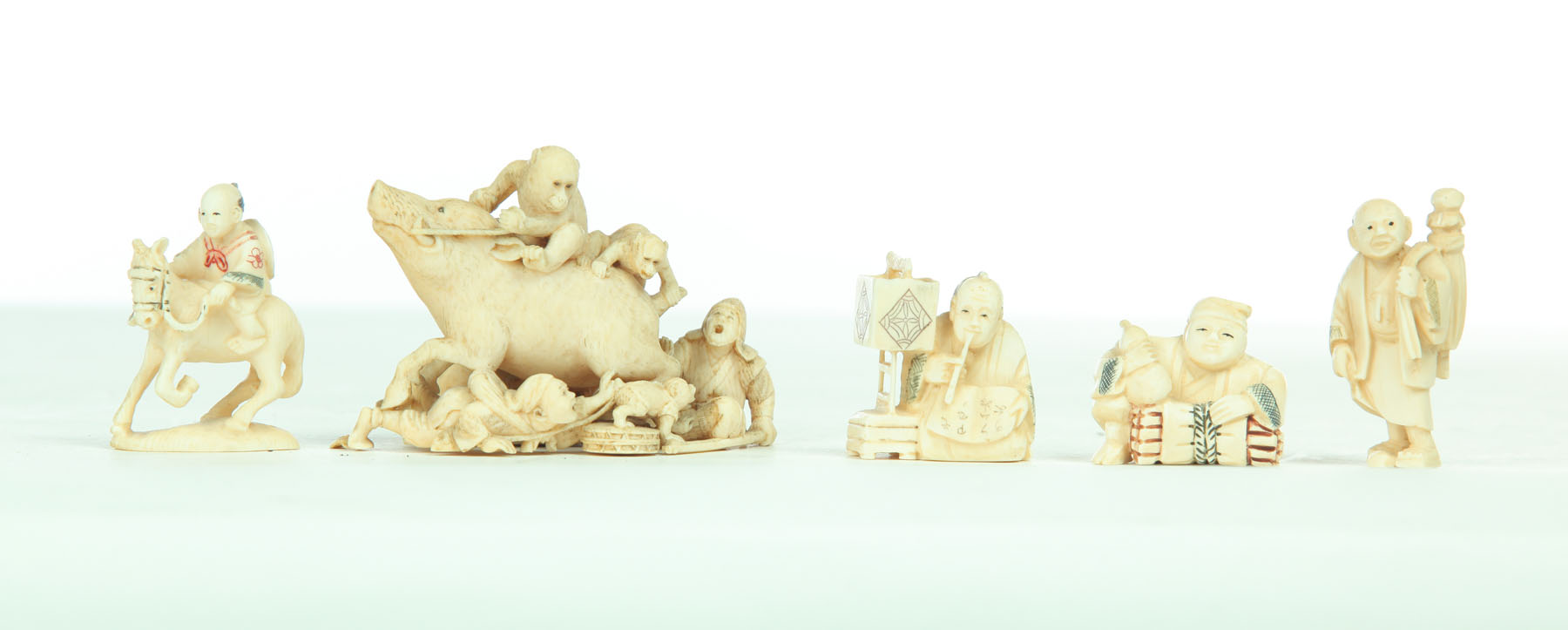 Appraisal: FIVE IVORY CARVINGS Japan th century Four netsuke of standing