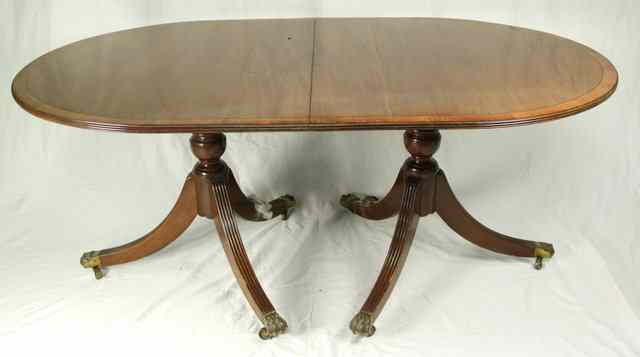 Appraisal: A George III style two pillar dining table with crossbanded