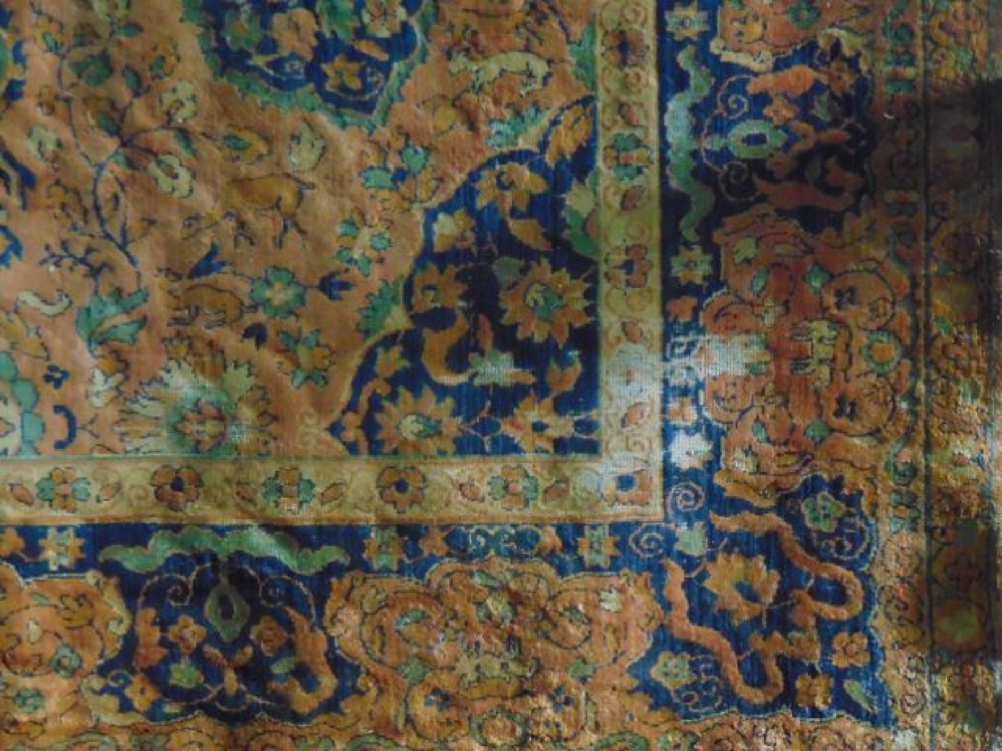 Appraisal: An extensive wool carpet with terracotta ground with foliate medallion