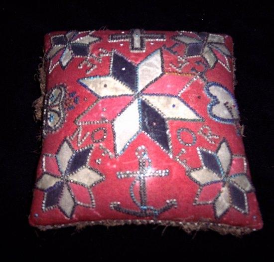 Appraisal: An early th Century embroidered pinwork cushion with sailor's farewell