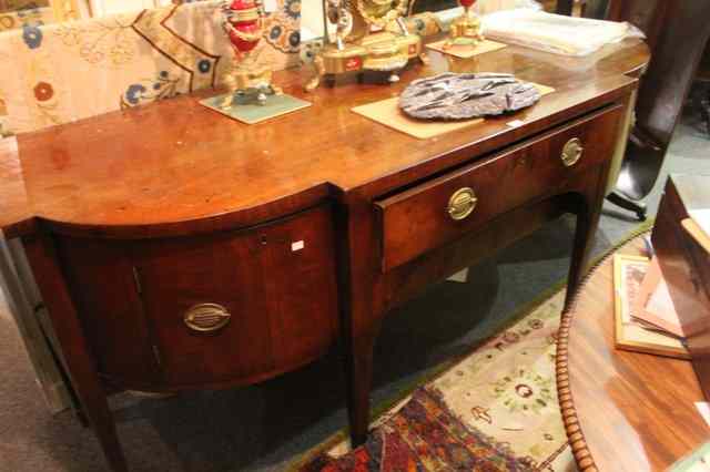 Appraisal: A GEORGIAN MAHOGANY BREAKFRONT SIDEBOARD central section fitted with two