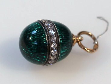 Appraisal: A green enamel egg shaped pendant with a diamond banding