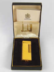 Appraisal: A Dunhill gas cigarette lighter with gilt mounted yellow panels