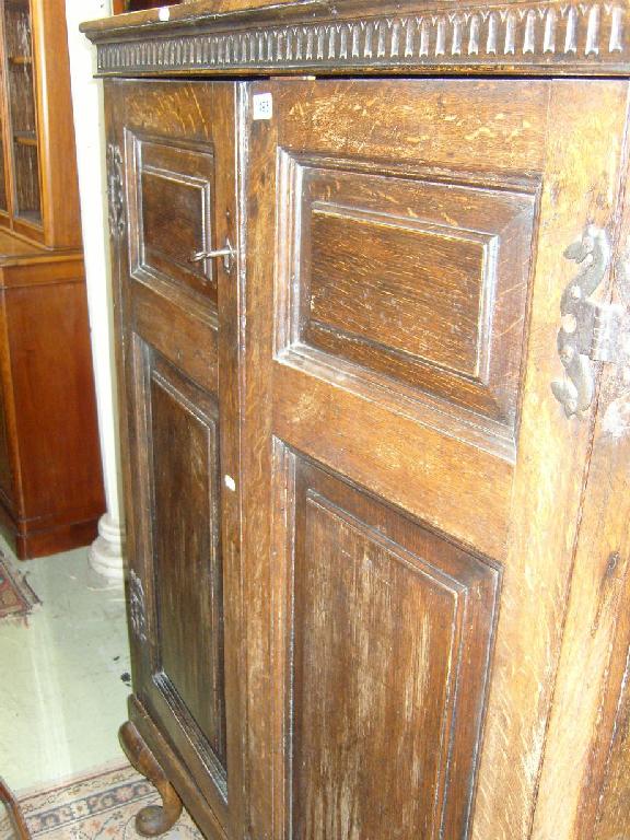 Appraisal: An Old English oak side cupboard enclosed by a pair