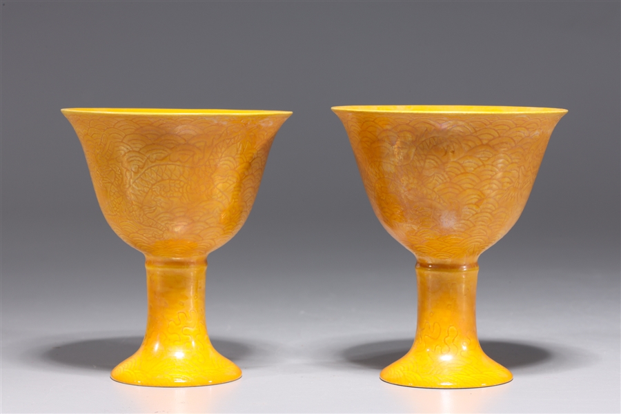 Appraisal: Two Chinese yellow ground porcelain wine cups with incised dragon