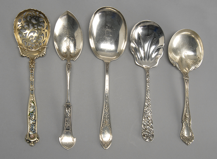 Appraisal: FIVE AMERICAN SILVER SERVING SPOONS An enamel and gold-washed pierced