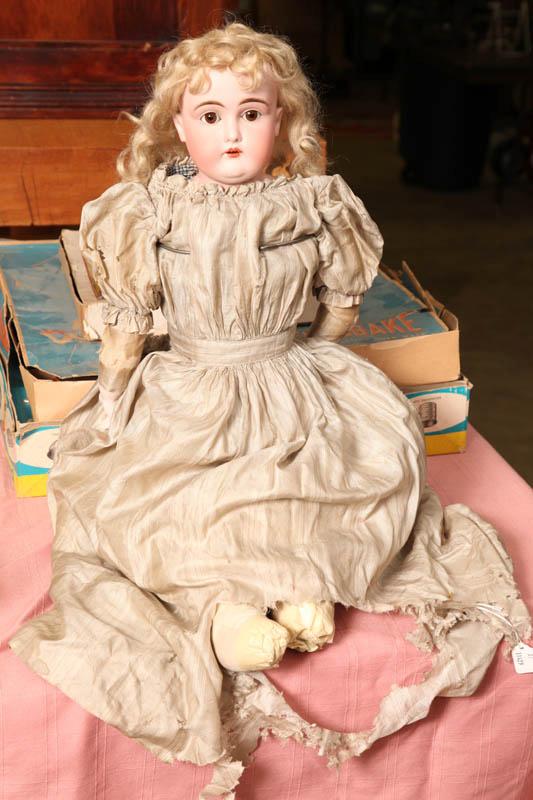 Appraisal: BISQUE HEAD DOLL Unmarked with brown glass eyes and an