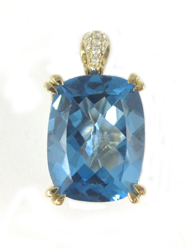 Appraisal: BLUE TOPAZ AND DIAMOND PENDANT k yellow gold ring with