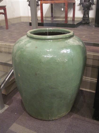 Appraisal: Large Chinese green glazed ear The nware storage jarTall cylindrical