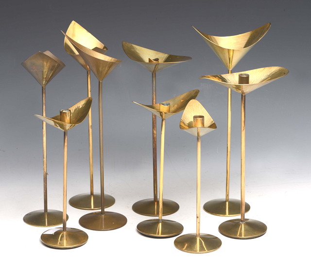 Appraisal: Kenneth Clark - A set of nine brass candlesticks with