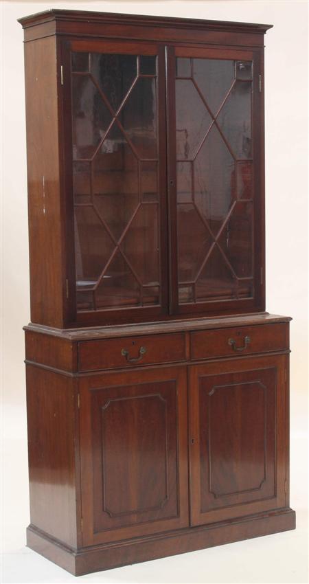 Appraisal: A Georgian style mahogany bookcase and undercabinet the plain cornice