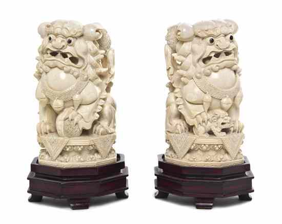 Appraisal: A Pair of Carved Ivory Fu Lions the lions depicted