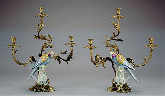 Appraisal: Pair porcelain and metal-mounted candelabra porcelain parrot on stump supporting