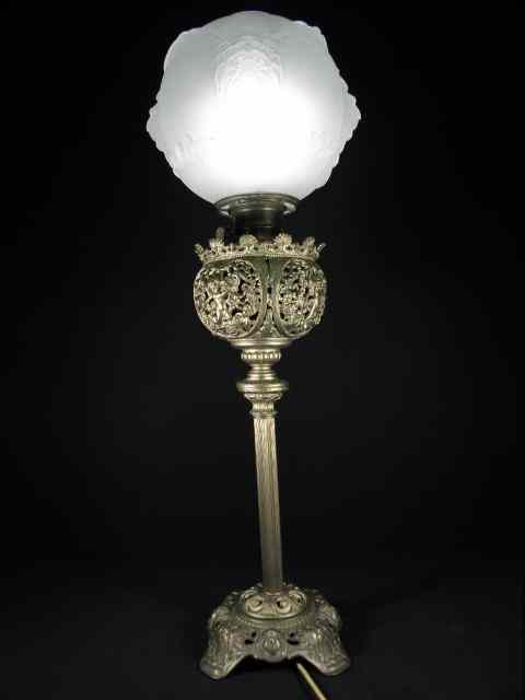 Appraisal: A Victorian gilt brass column style oil lamp Frosted glass