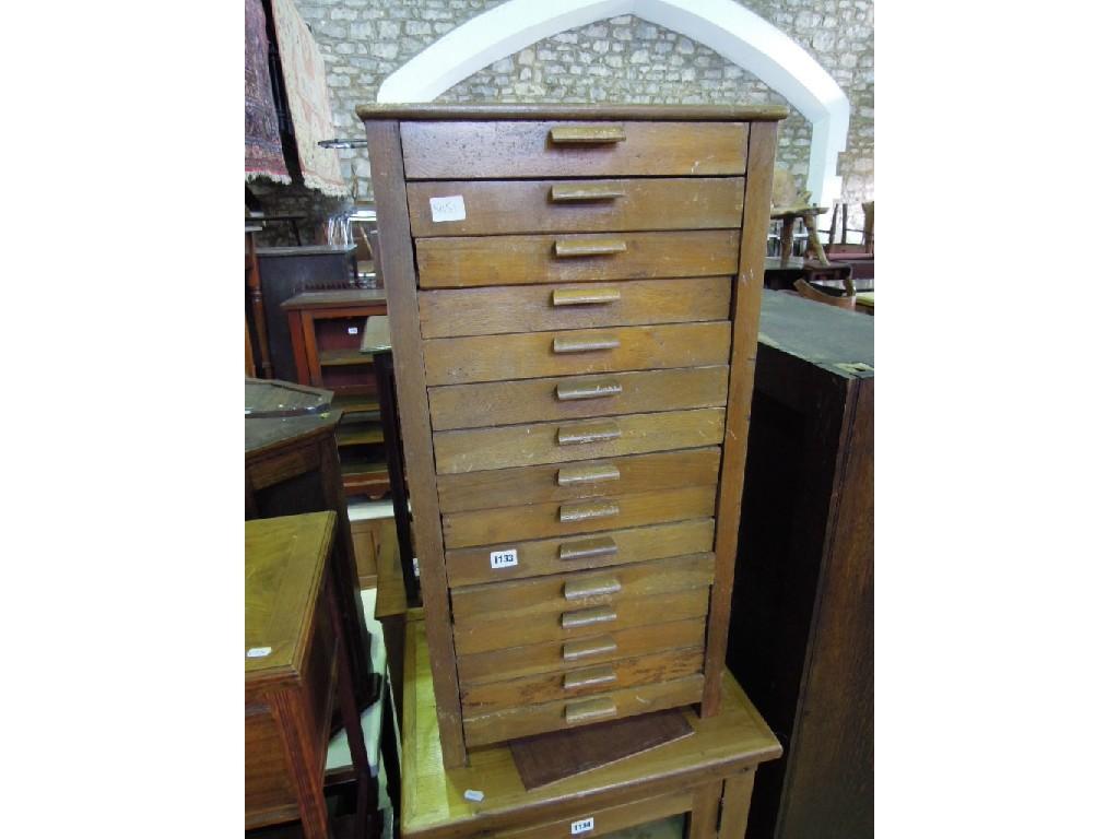 Appraisal: A small oak pedestal chest fitted with an arrangement of