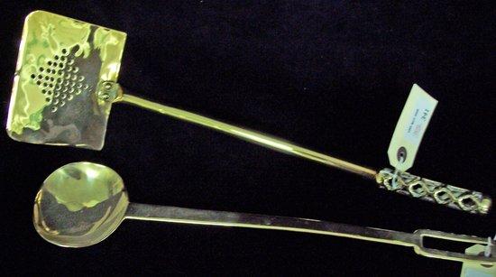 Appraisal: A brass ladle with pierced handle and a pierced brass