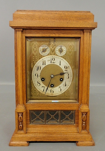 Appraisal: - German oak mantel clock with a three-train movement by