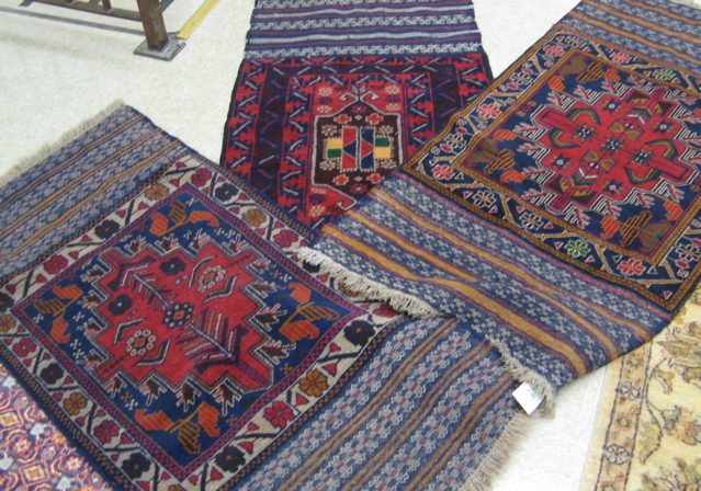 Appraisal: THREE AFGHAN TRIBAL BELOUCH SADDLE BLANKETS each about ' x