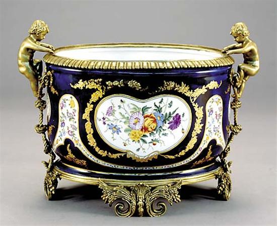 Appraisal: Gilt metal-mounted porcelain jardiniere putti climbing rope on sides clutching