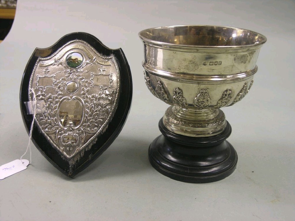 Appraisal: A silver trophy circular pedestal form cast with scroll devices