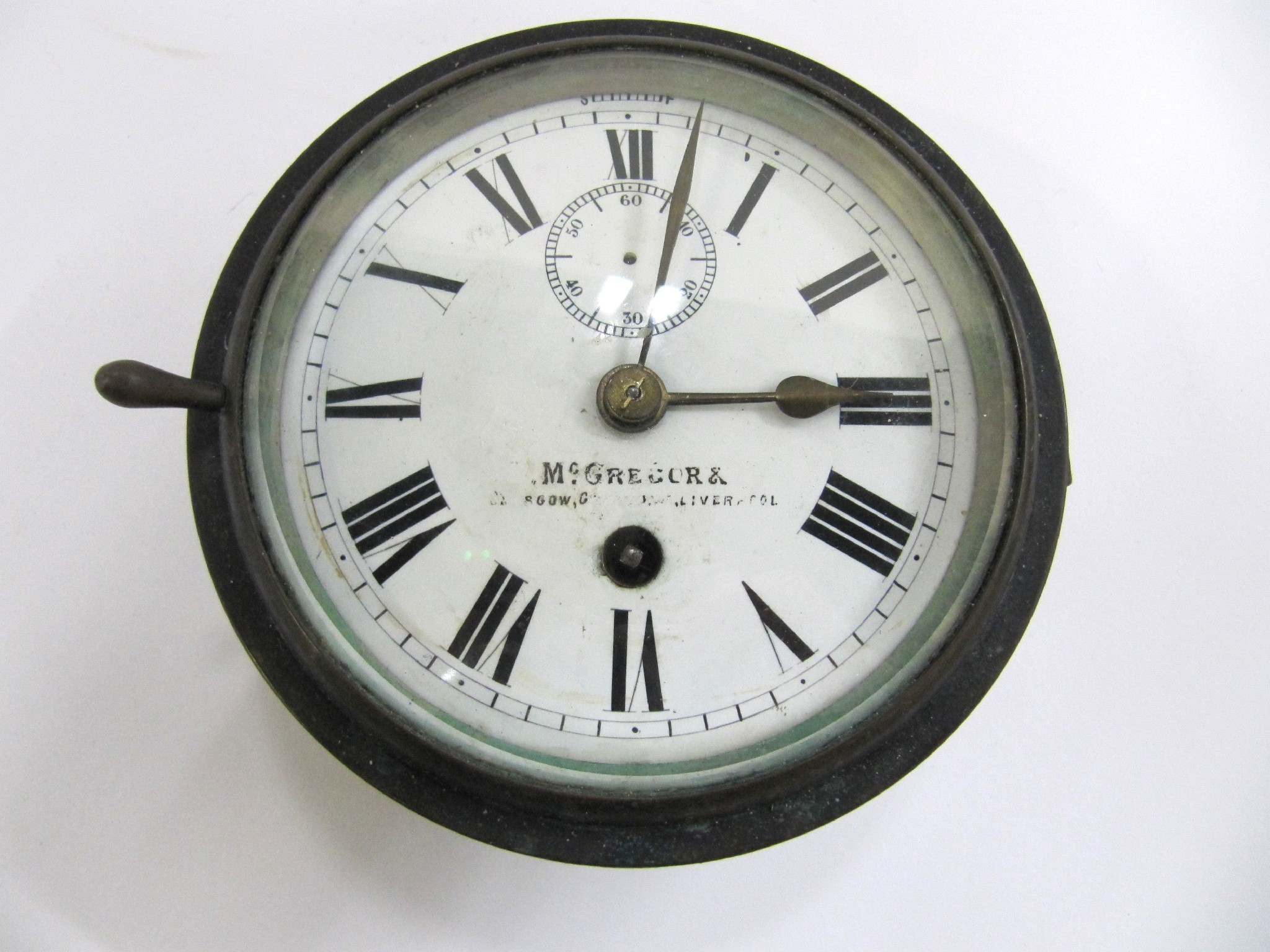 Appraisal: A bulkhead clock the enamel dial marked McGregor