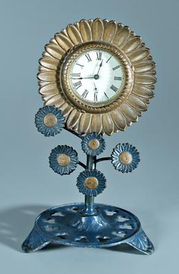 Appraisal: Cast iron sunflower clock blooming sunflower above three petal base