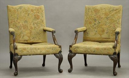 Appraisal: PAIR OF GEORGE III MAHOGANY CARVED LIBRARY ARMCHAIRSEach needlepoint upholstered