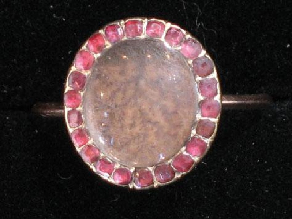 Appraisal: A GEORGE II MEMORIAL RING with an oval moss hairwork