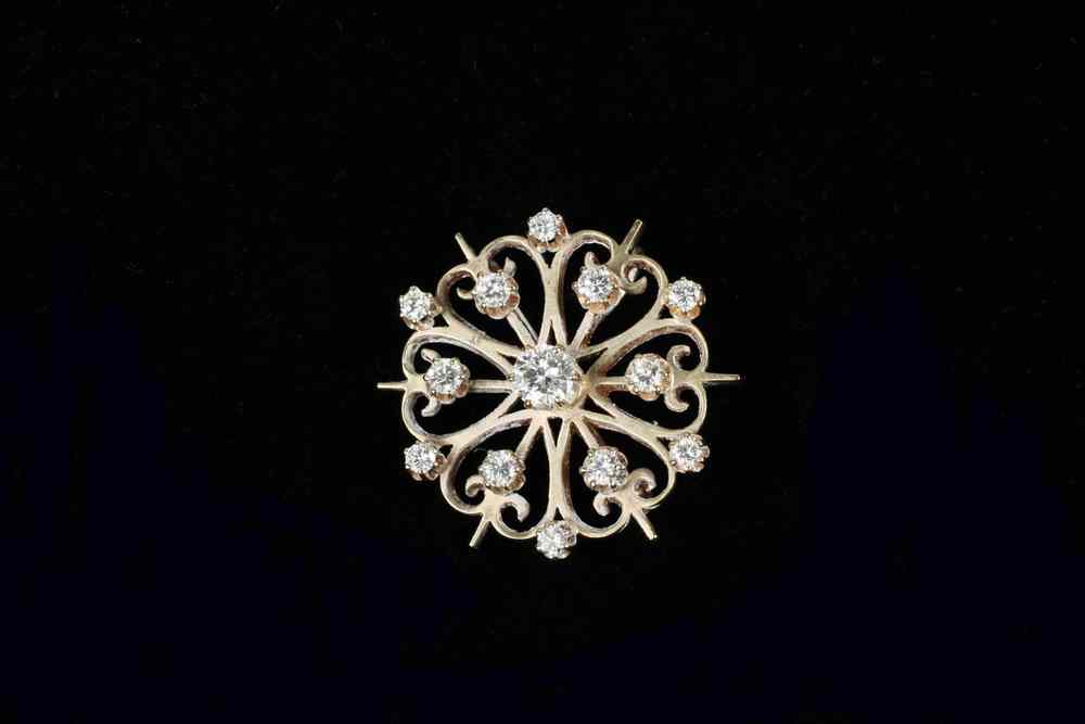 Appraisal: PENDANT BROOCH - One K yellow gold and diamond starburst