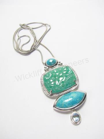 Appraisal: A sterling silver pendant x with carved jade center oval