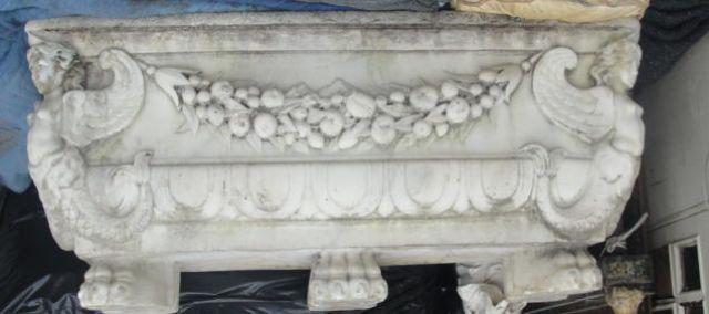 Appraisal: Marble Planter with Winged Figures Garlands and Claw feet As