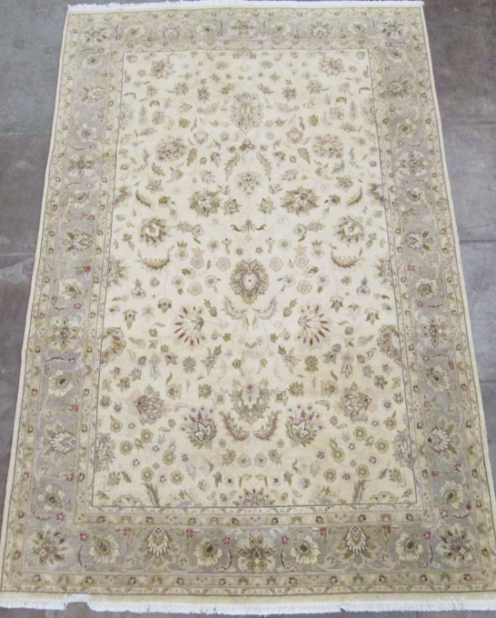 Appraisal: HAND KNOTTED ORIENTAL CARPET Pakistani-Persian overall floral decoration on khaki