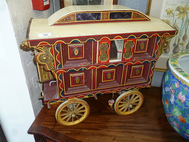 Appraisal: A POLYCHROME PAINTED MODEL OF A GYPSY CARAVAN with spoked