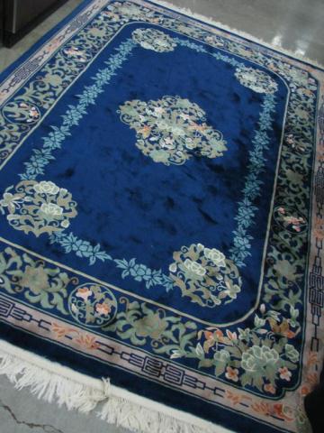 Appraisal: Chinese Floral Area Rug with cobalt blue field and tan