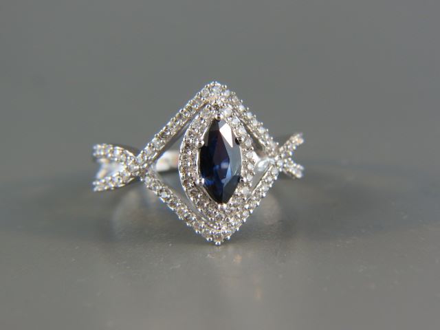 Appraisal: Sapphire and Diamond Ring deep blue carat marquise sapphire surrounded