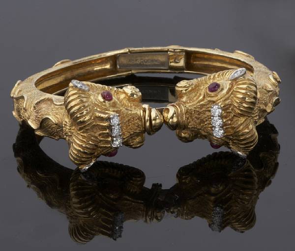 Appraisal: A diamond and ruby bangle Tobias the hinged bangle depicting