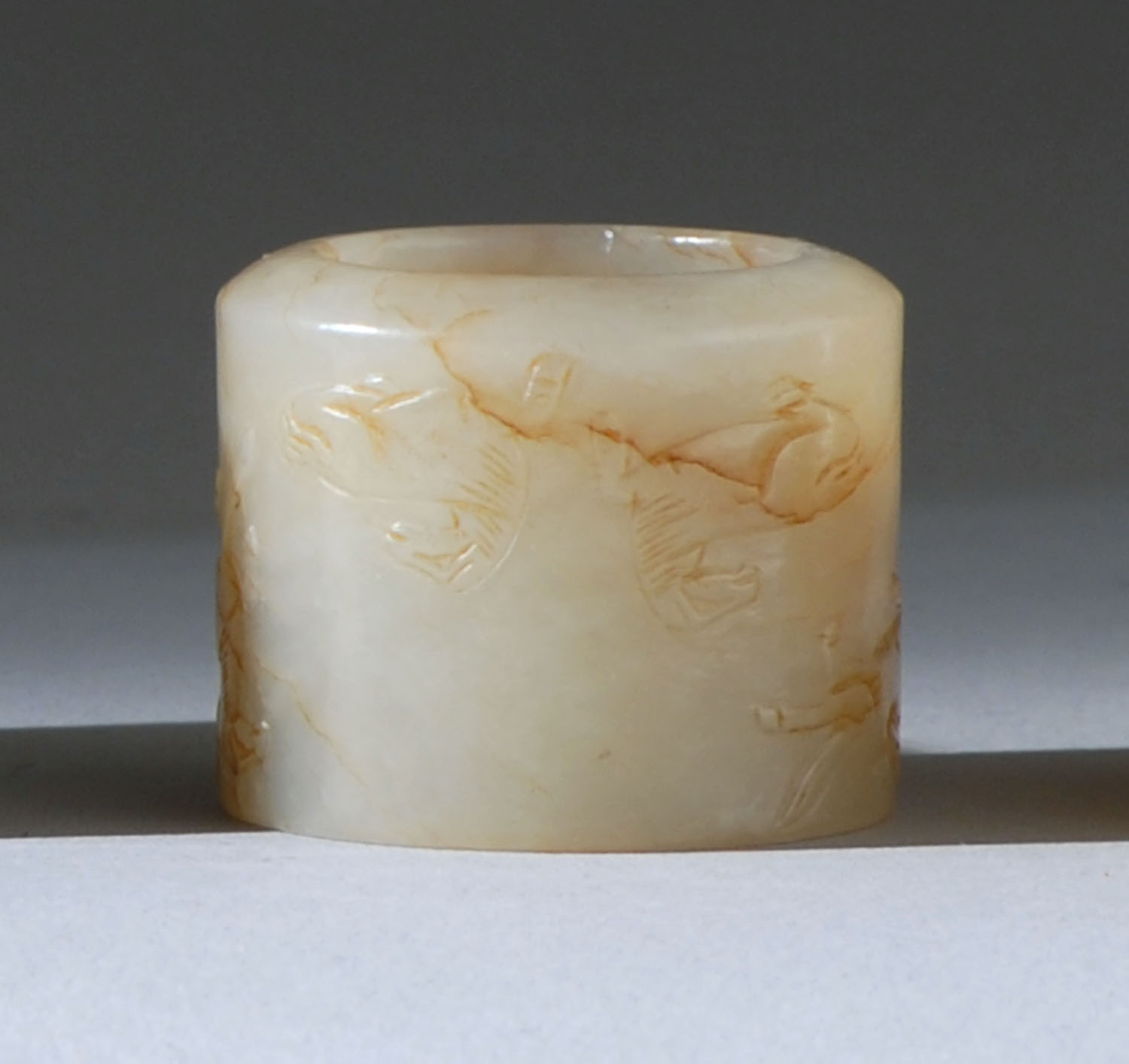 Appraisal: WHITE AND RUSSET JADE THUMB RING th th CenturyCarved with